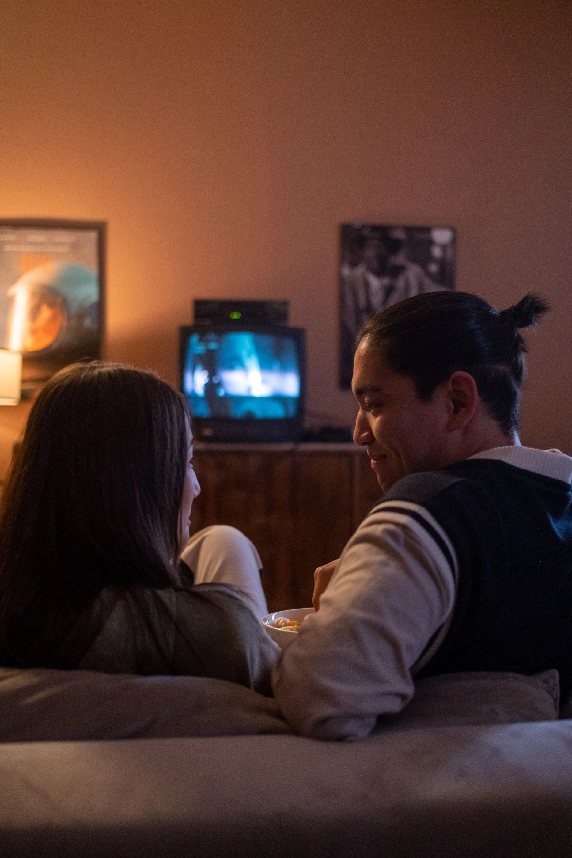 A couple on a couch watching television