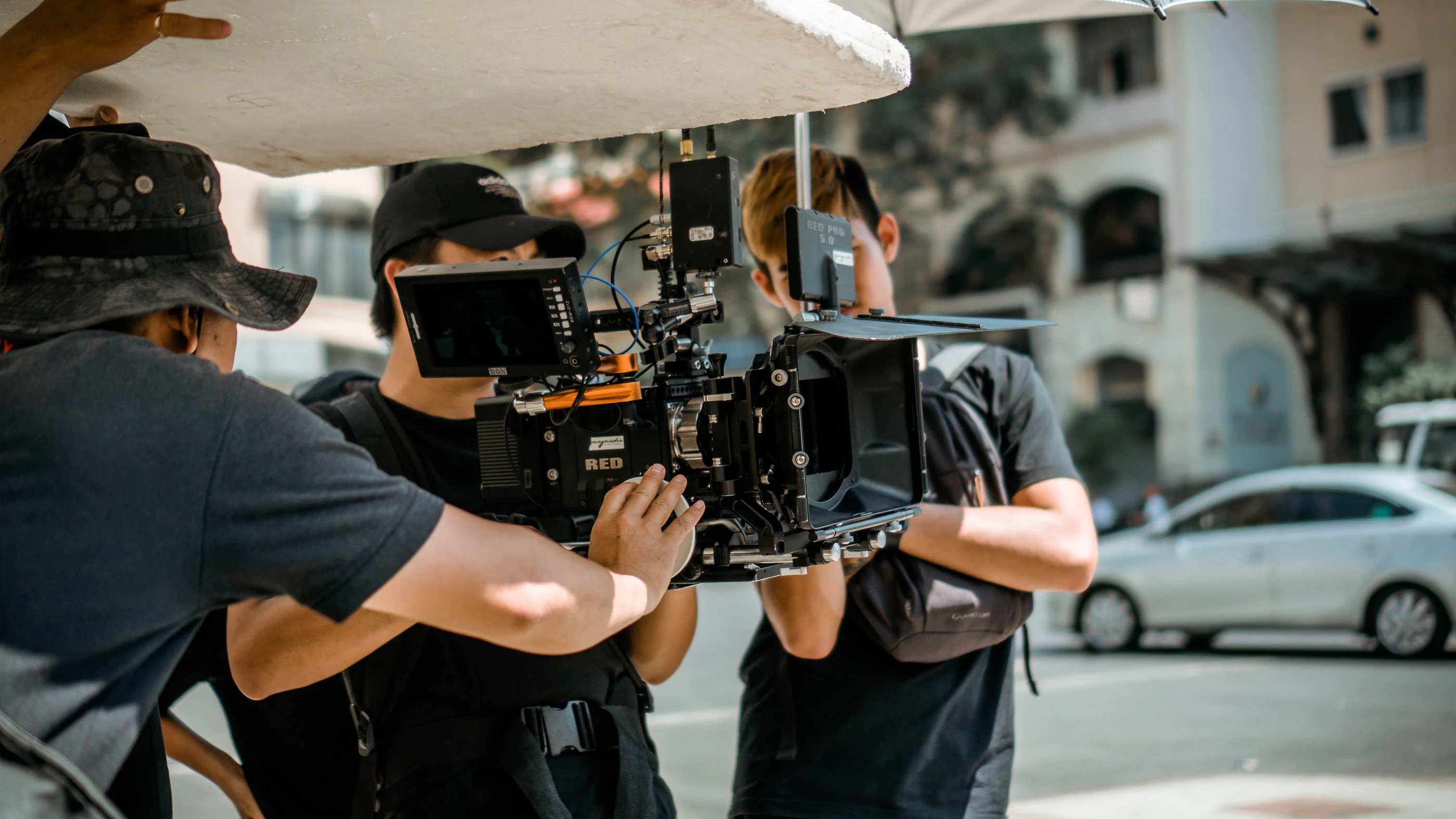 A film crew with a cinema camera on a city street